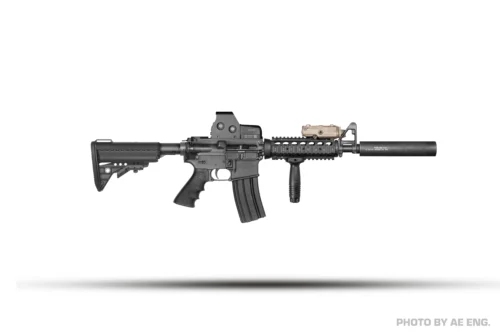 Black AR-style rifle with a suppressor, foregrip, optic sight, and rail attachments laid horizontally on a white background.