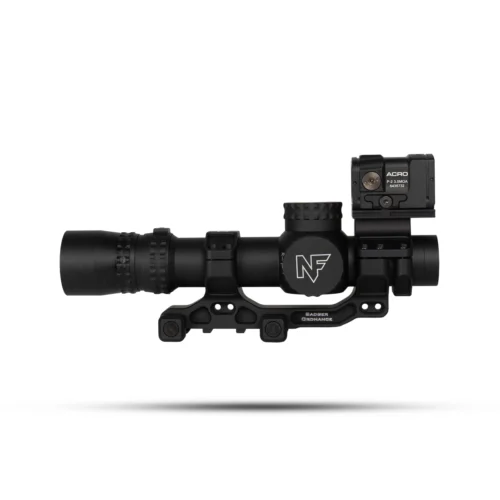 Black tactical rifle scope with a side-mounted Acro red dot sight and rail mount, shown in mid-air.
