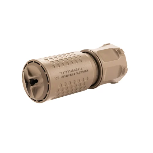 Close-up of a tan tactical firearm accessory (muzzle device/suppressor) with knurled texture and mounting area, shown from a side angle.
