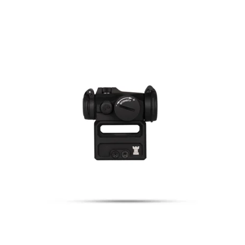 Black compact red-dot sight mounted on a rail adapter, shown against a white background with a soft shadow. (Informative, function: aiming device)