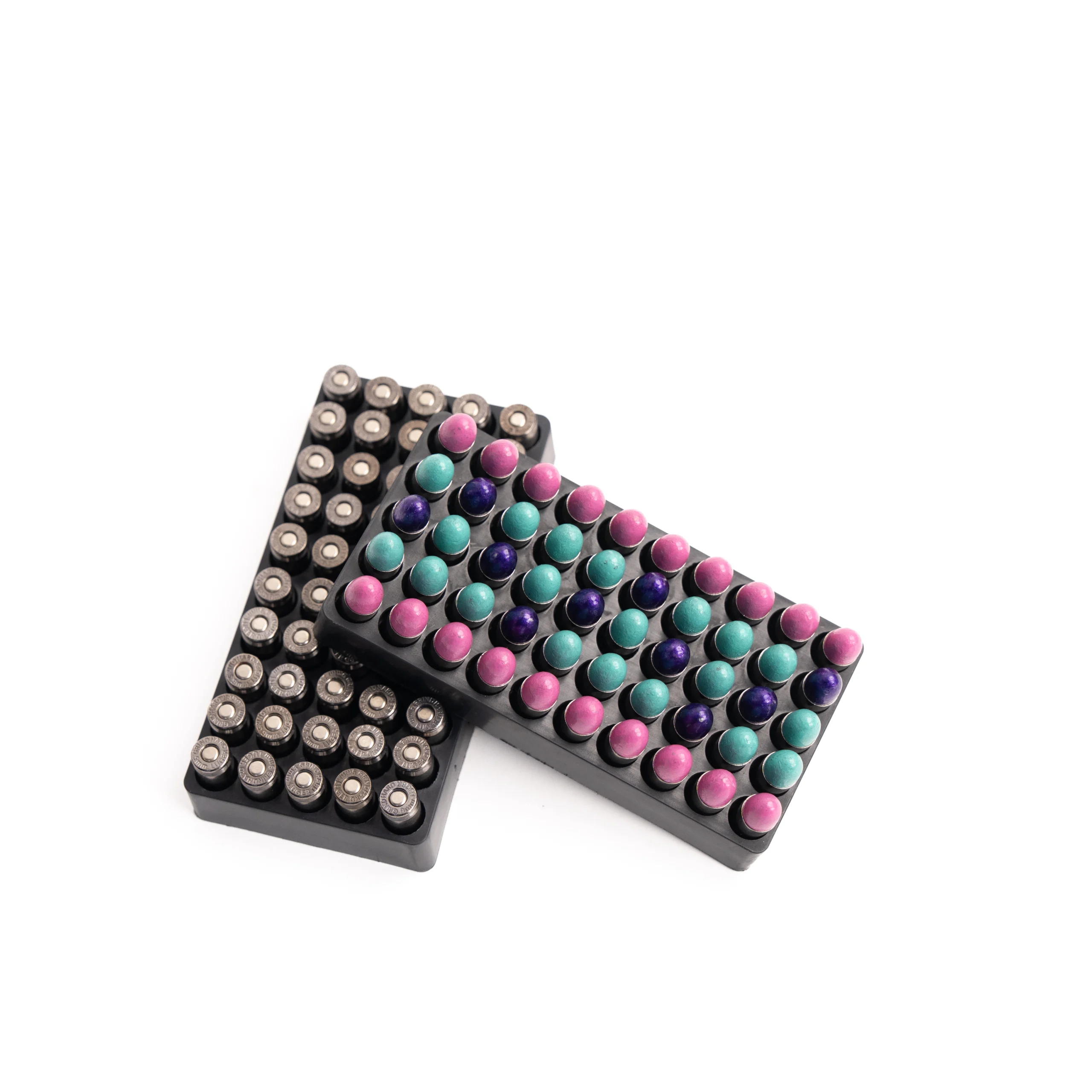 M3 – Badlands Munitions Co Assorted marker pens with colorful round caps arranged in black trays on a white surface.