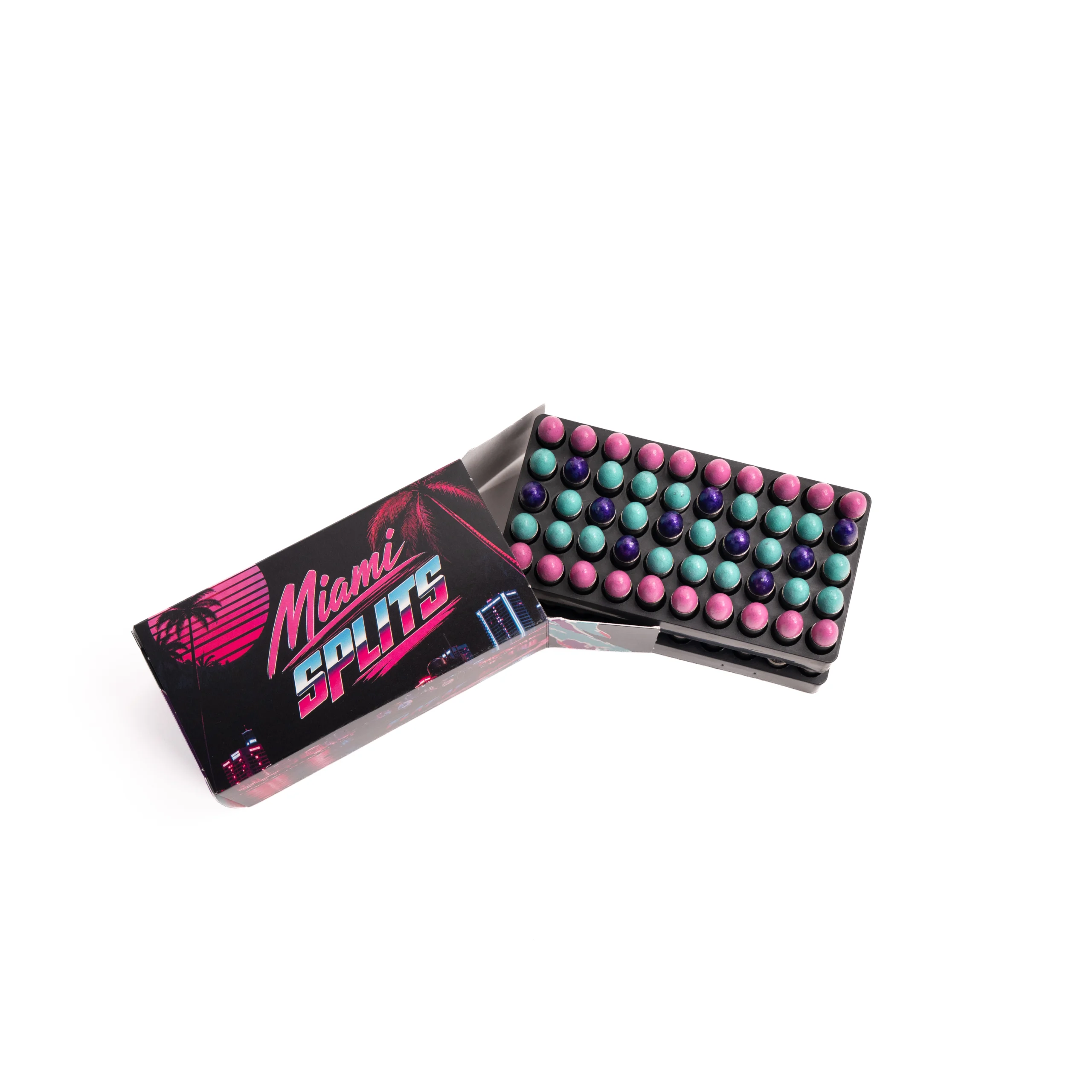 M5 – Badlands Munitions Co Open Miami Lights eyeshadow palette with multiple rows of colorful circular pans (pink, teal, purple). The bold graphic packaging features tropical palm design and neon lettering.