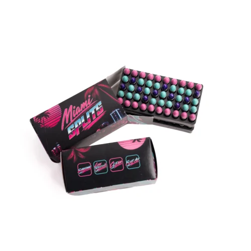 Open black box with pink, teal, and purple spherical beads arranged in a grid, next to a retro-style package with Palm design and neon text.